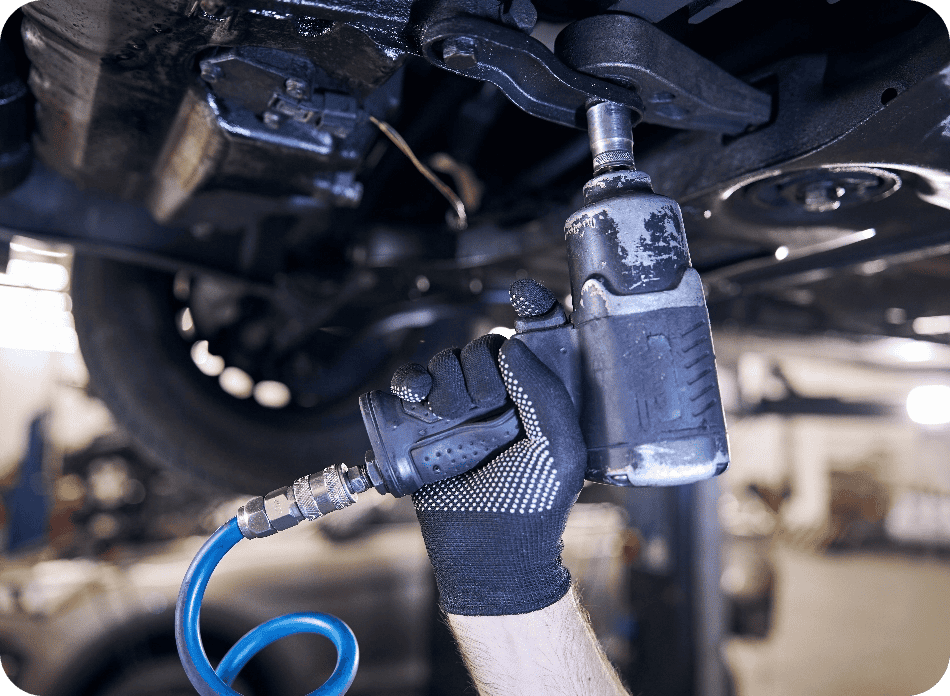 car-mechanic-using-impact-wrench-at-auto-repair-st-2021-09-03-22-33-55-utc@2x